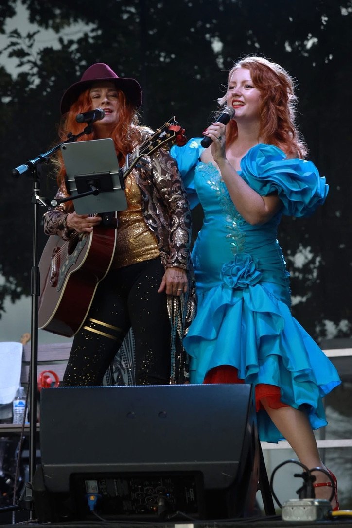 Victoria and Liz singing at an outdoor show