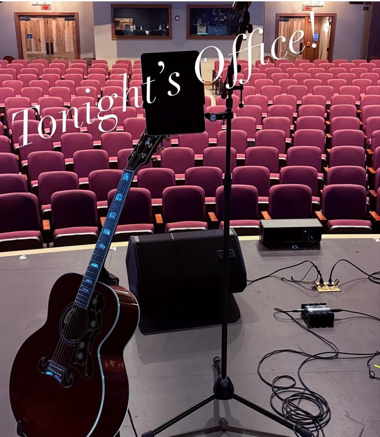 Tonight's office: guitar and empty theater seats