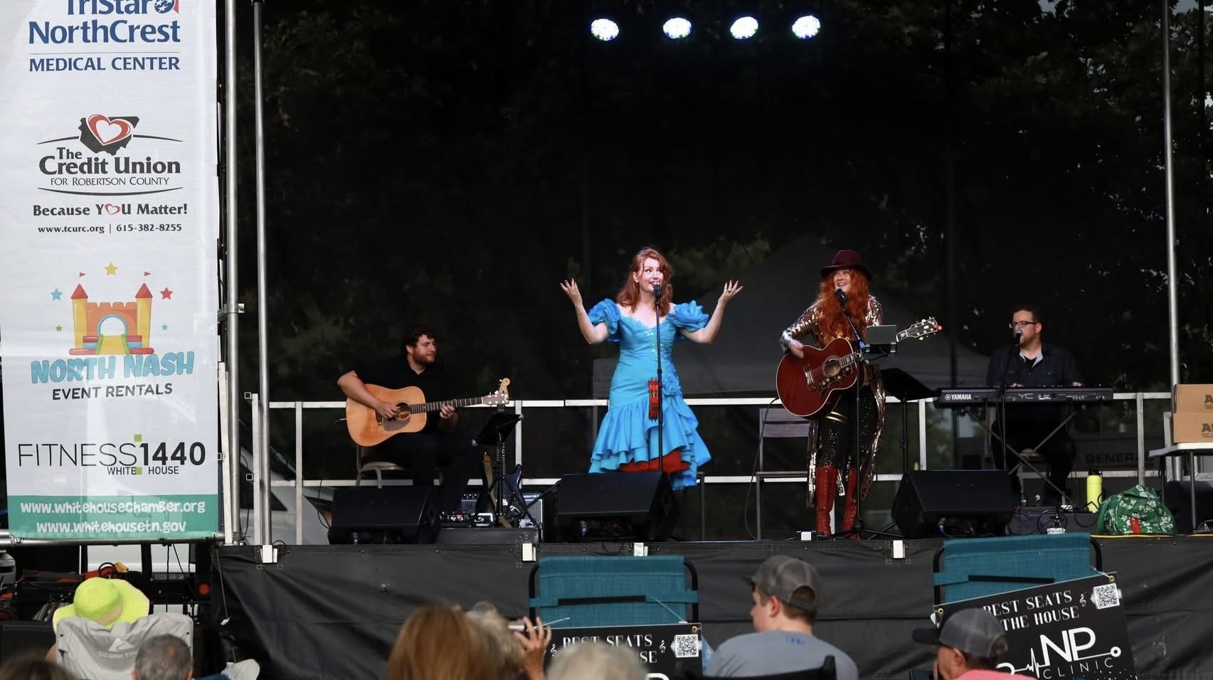 Full band performing at an outdoor festival stage